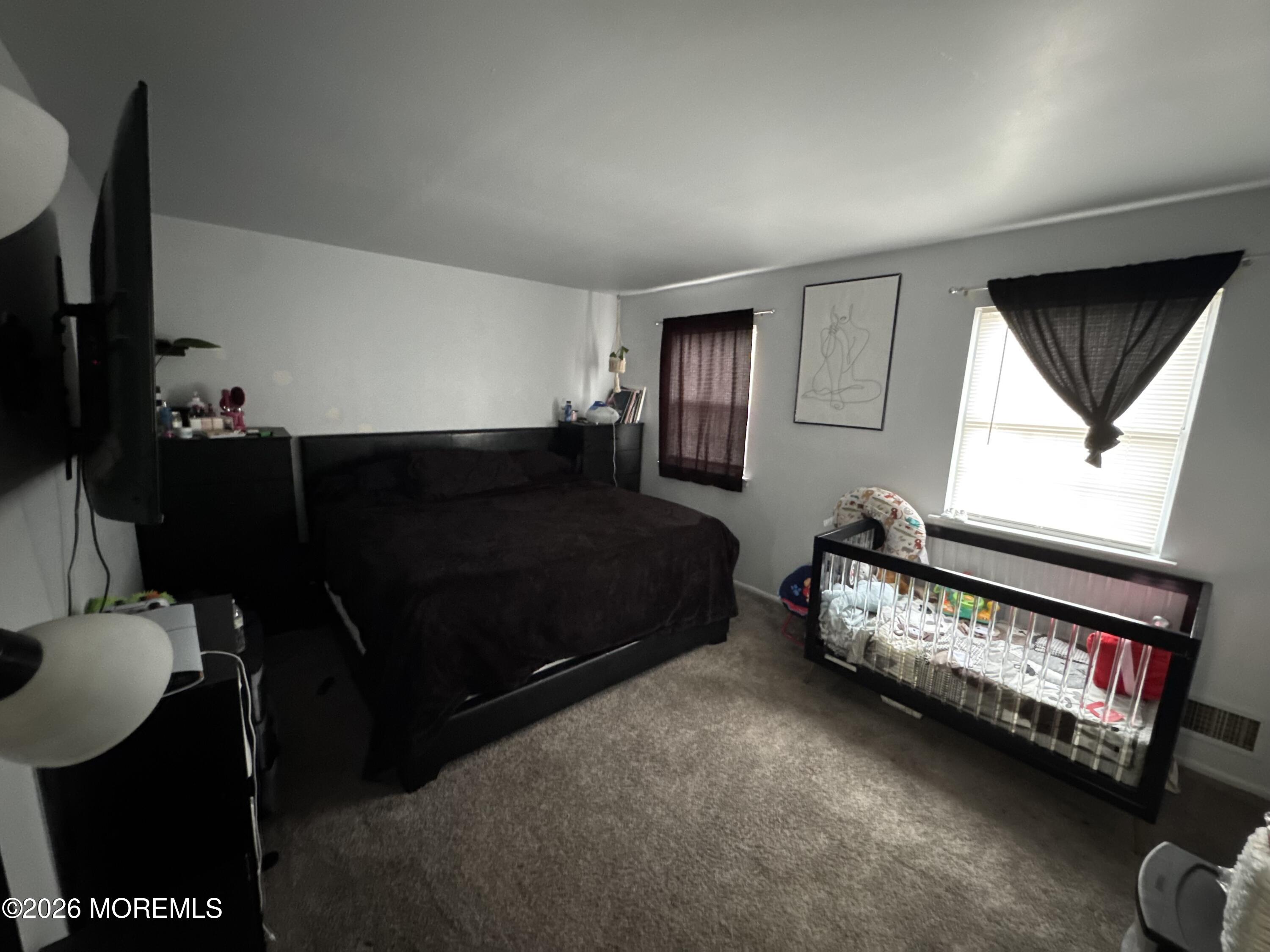 112 Greenwood Loop Road Brick, NJ 08724 - Photo 11 of 14 a living room with furniture a flat screen tv and a window