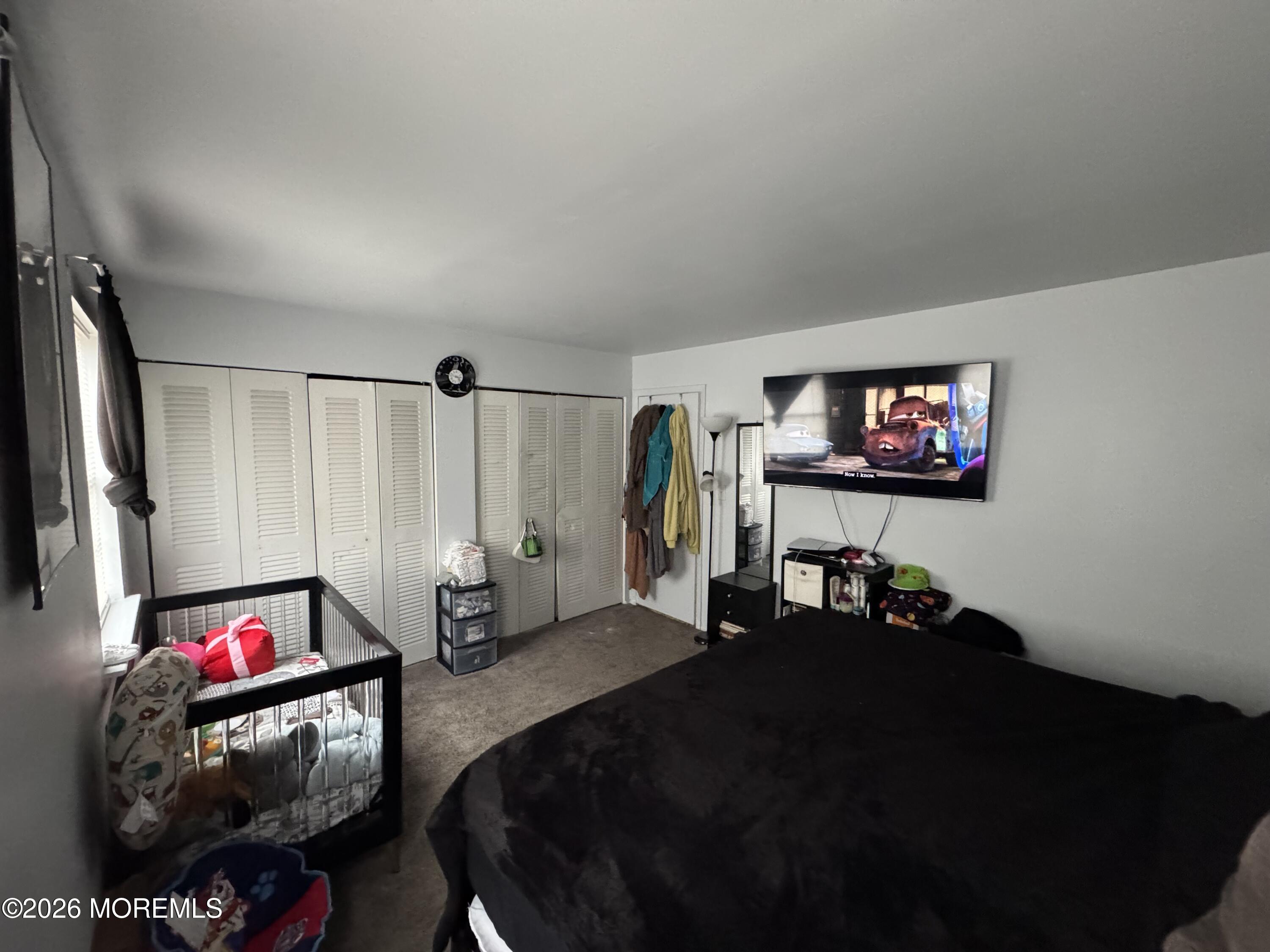 112 Greenwood Loop Road Brick, NJ 08724 - Photo 14 of 14 a living room with furniture a flat screen tv and a lamp