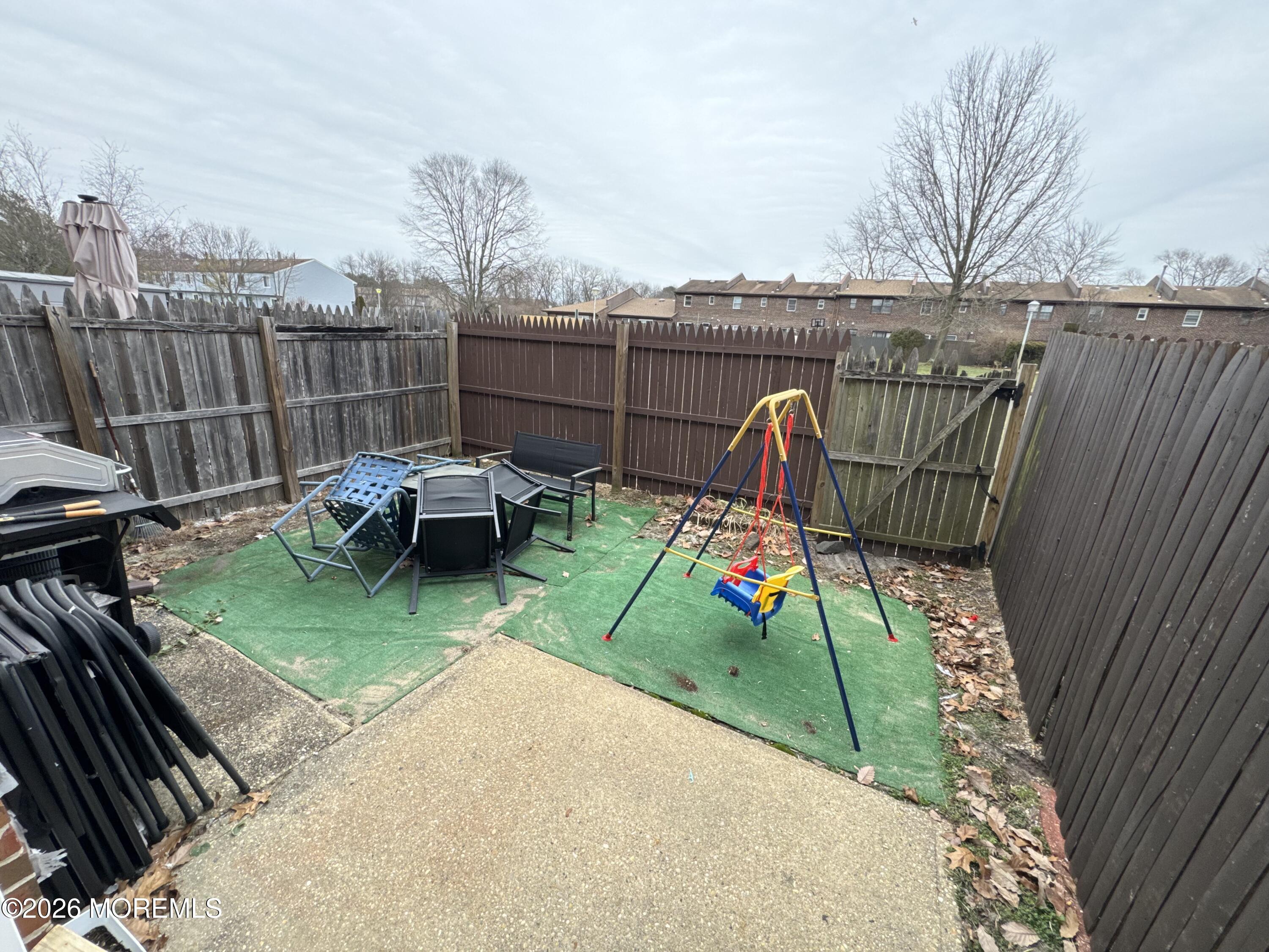 112 Greenwood Loop Road Brick, NJ 08724 - Photo 8 of 14 a view of a wooden fence and bench in the backyard