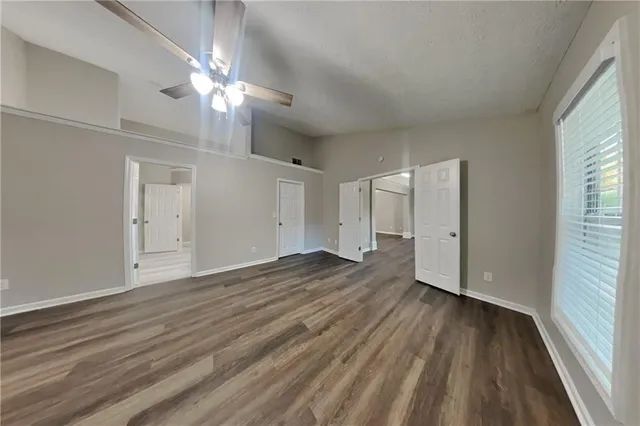 a view of wooden floor and windows in a room