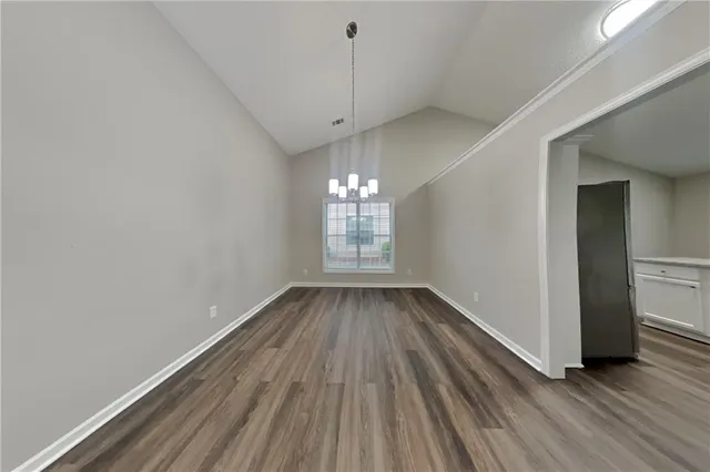 a view of a room with wooden floor and window