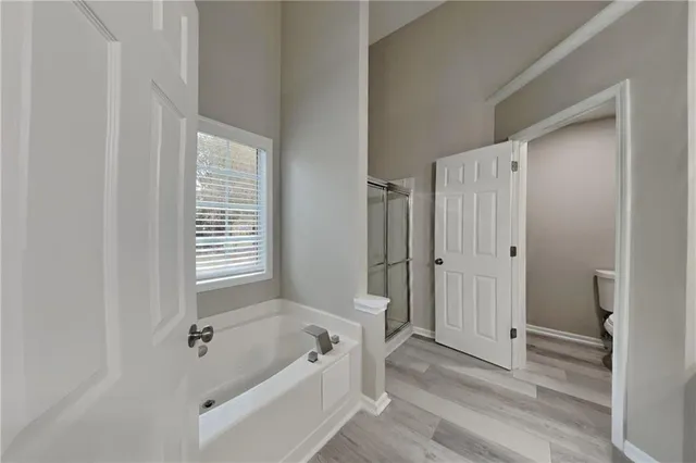 a bathroom with a tub a sink and a shower
