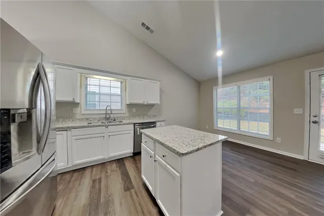 a kitchen with a sink stove and refrigerator