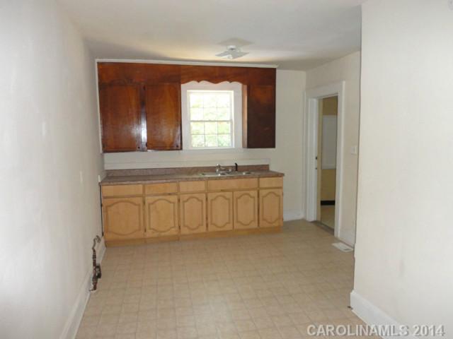 3912 Tuckaseegee Road Charlotte, NC 28208 - Photo 2 of 5 a bathroom with a sink a mirror and a bathtub