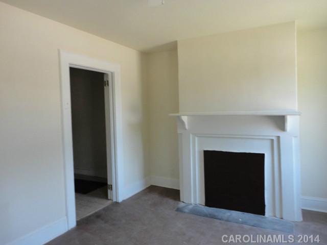 3912 Tuckaseegee Road Charlotte, NC 28208 - Photo 3 of 5 a view of an empty room with a fireplace