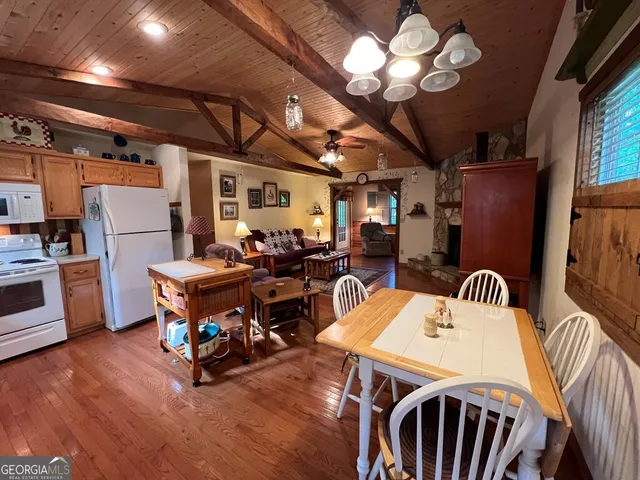 a view of a dining room with furniture a chandelier and wooden floor