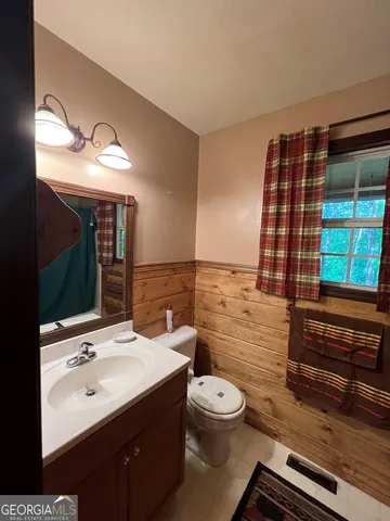a bathroom with a shower and a glass door