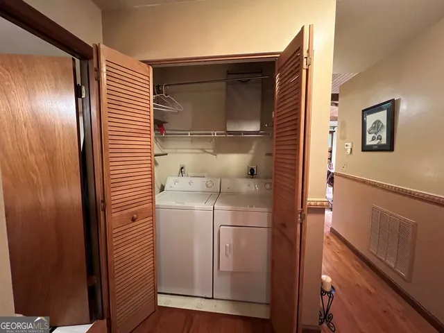 a bedroom with a bed a dresser next to a window