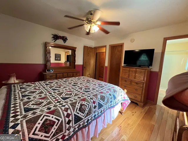 a bathroom with a sink a toilet a mirror and shower