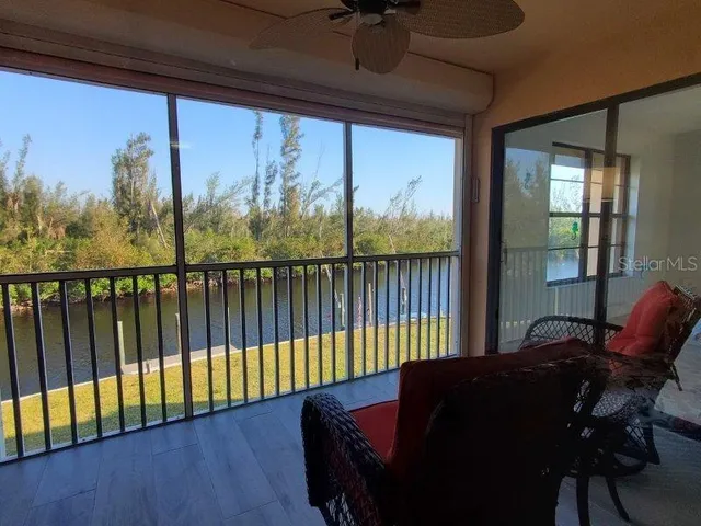 a living room with furniture and a floor to ceiling window