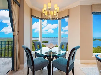 a view of a dining room with furniture a chandelier and wooden floor