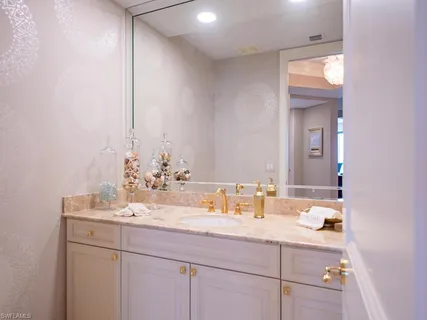 a bathroom with a double vanity sink toilet and a mirror