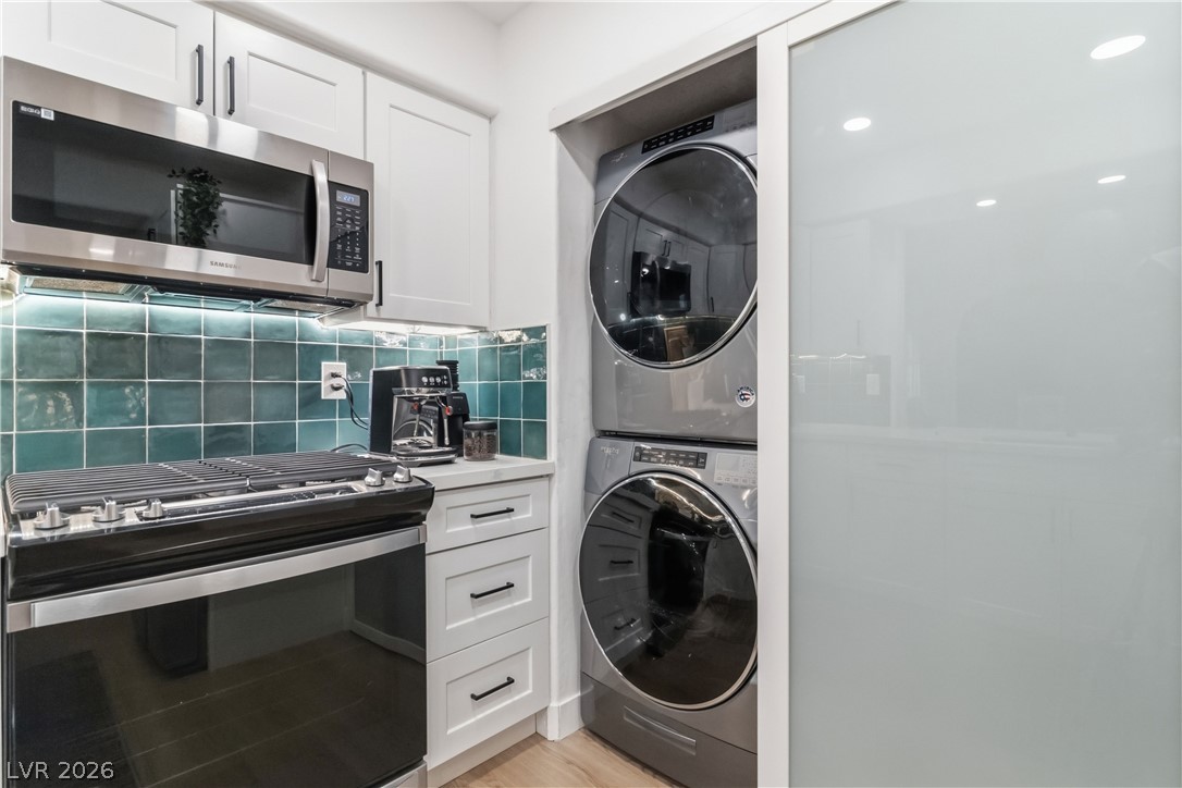 7950 West Flamingo Road, Unit 1180 Las Vegas, NV 89147 - Photo 23 of 26 A compact kitchen with an integrated laundry area, offering optimal use of space.