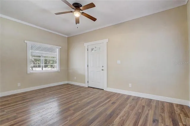 a view of a room wooden floor and a ceiling fan