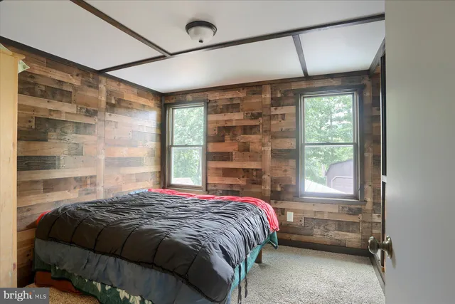 a bedroom with a bed and a window with bathroom