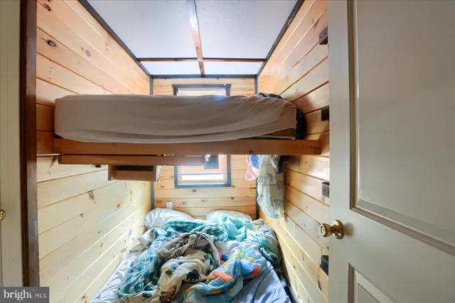 a view of a house with a wooden deck and furniture