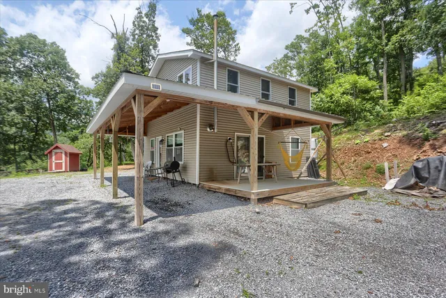 a outdoor living space with furniture and a flat screen tv