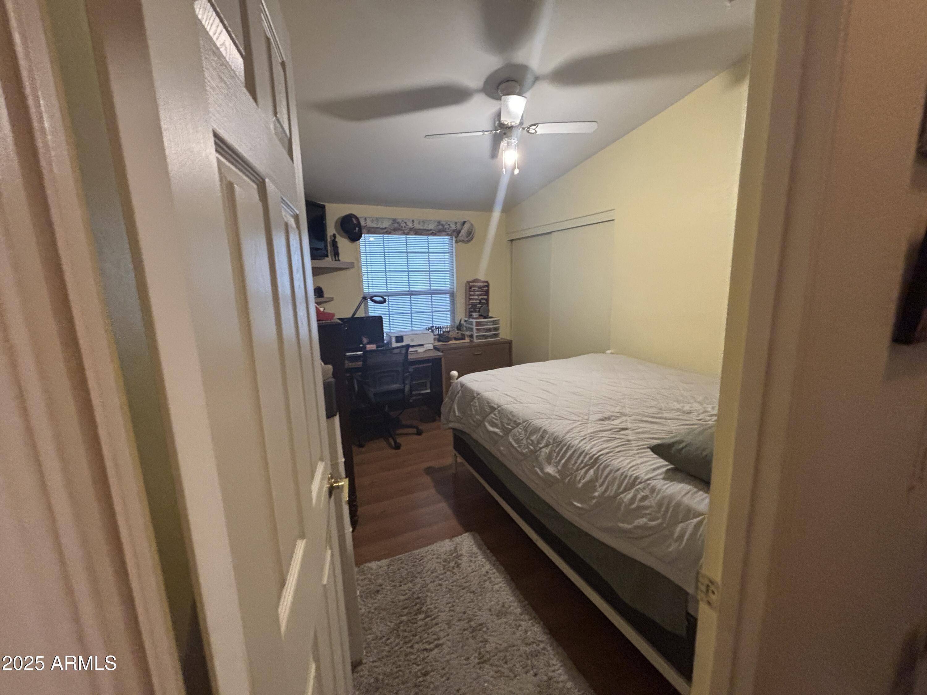 3500 South Tomahawk Road, Unit 153 Apache Junction, AZ 85119 - Photo 15 of 28 a bedroom with a bed and a chandelier