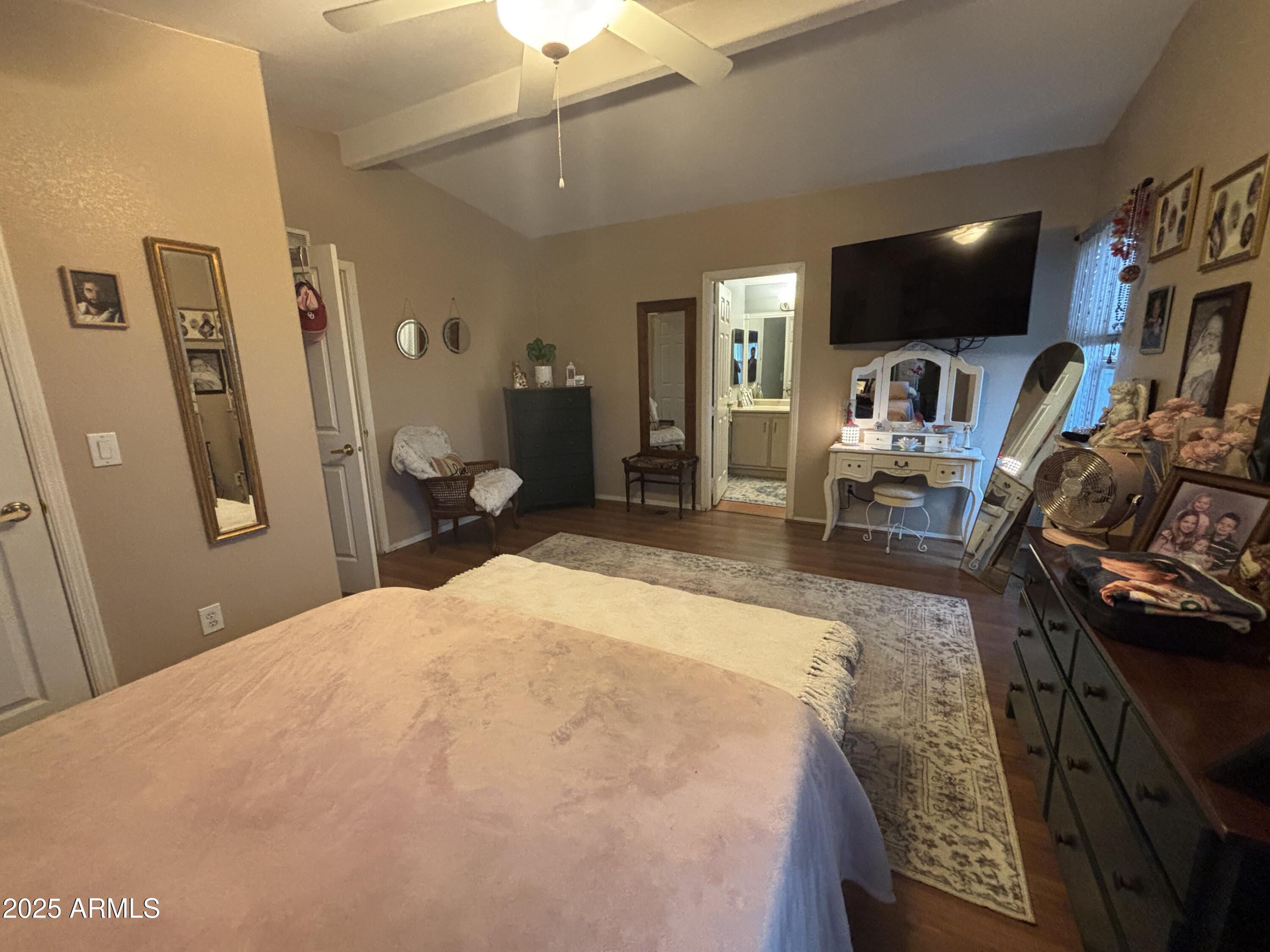 3500 South Tomahawk Road, Unit 153 Apache Junction, AZ 85119 - Photo 19 of 28 a bedroom with a bed a flat screen tv and dresser