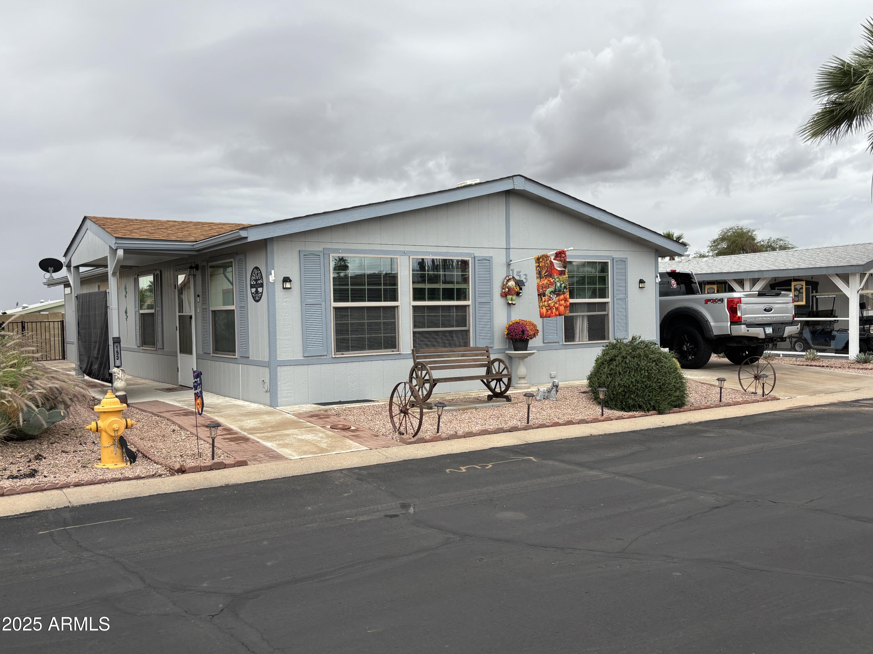 3500 South Tomahawk Road, Unit 153 Apache Junction, AZ 85119 - Photo 2 of 28 a group of people sitting in front of a house