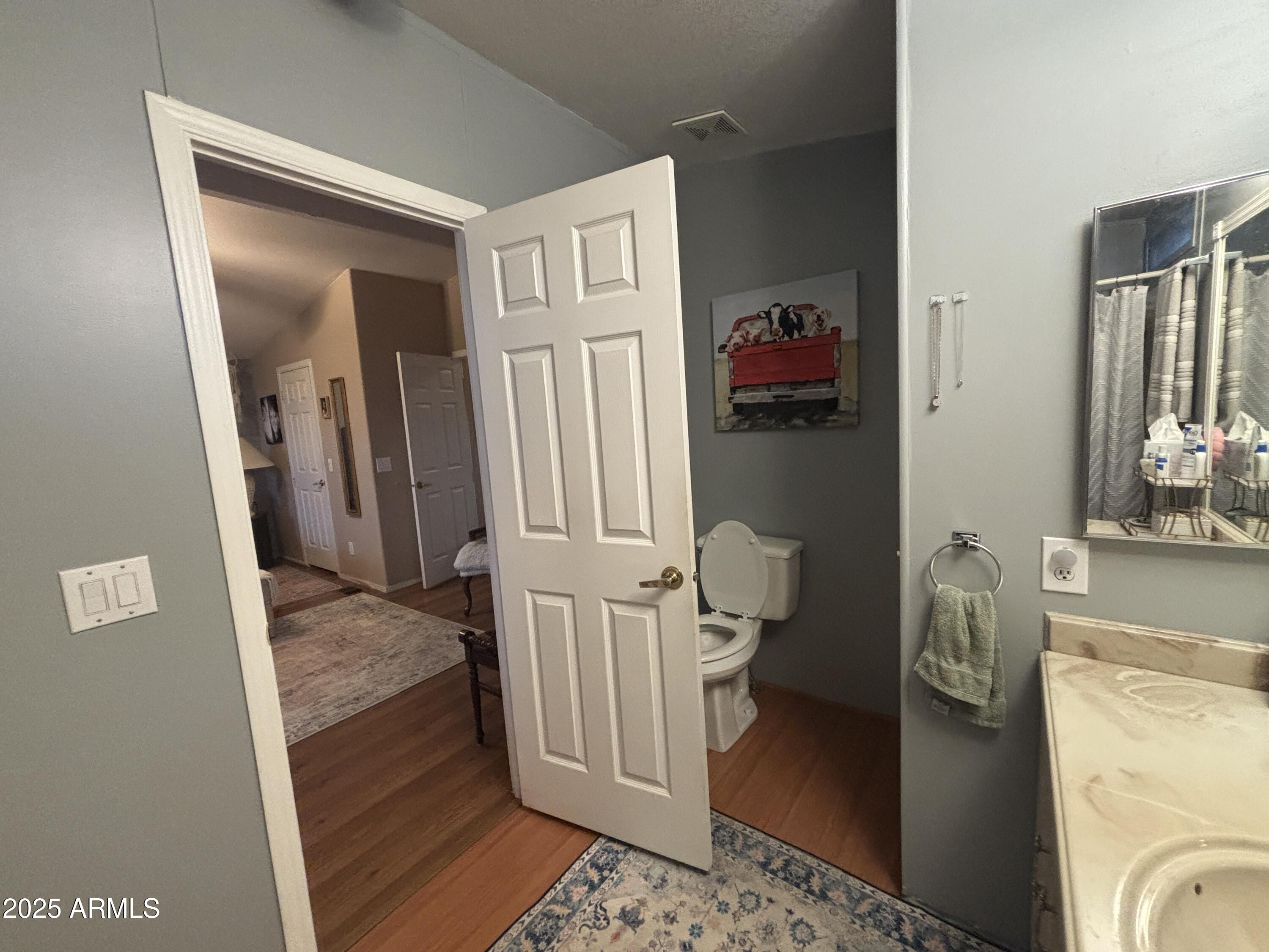 3500 South Tomahawk Road, Unit 153 Apache Junction, AZ 85119 - Photo 22 of 28 a view of a hallway with wooden floor and windows