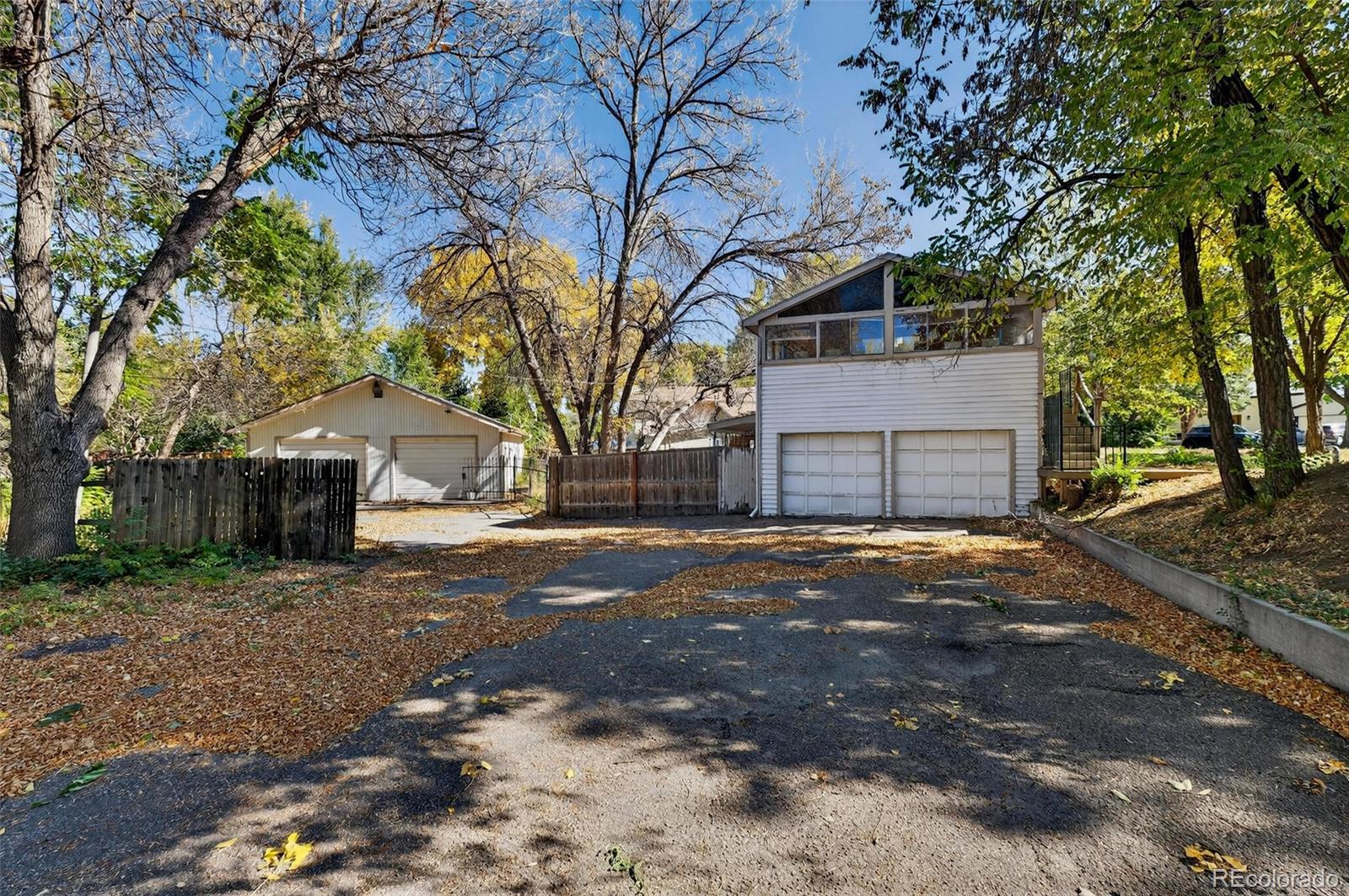 6795 West 31st Avenue Wheat Ridge, CO 80214 - Photo 21 of 35 a front view of a house with a yard and garage