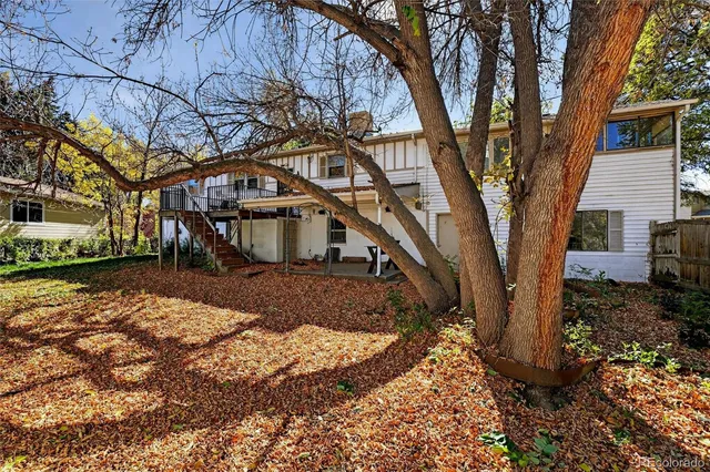 a view of a house with a yard and pathway