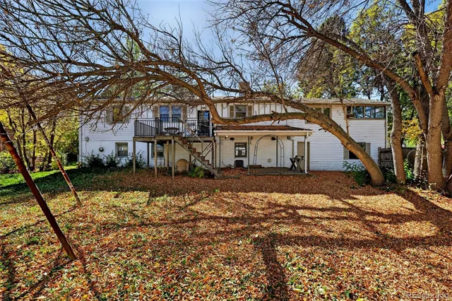 an aerial view of residential house with outdoor space and trees all around