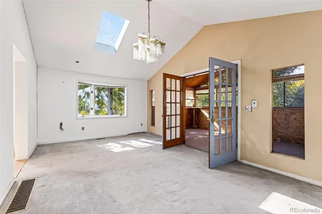 a view of a room with wooden floor and door