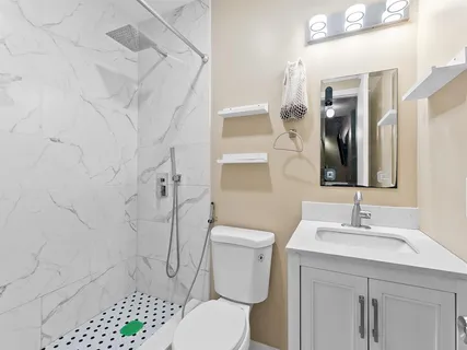 a bathroom with a sink toilet and shower