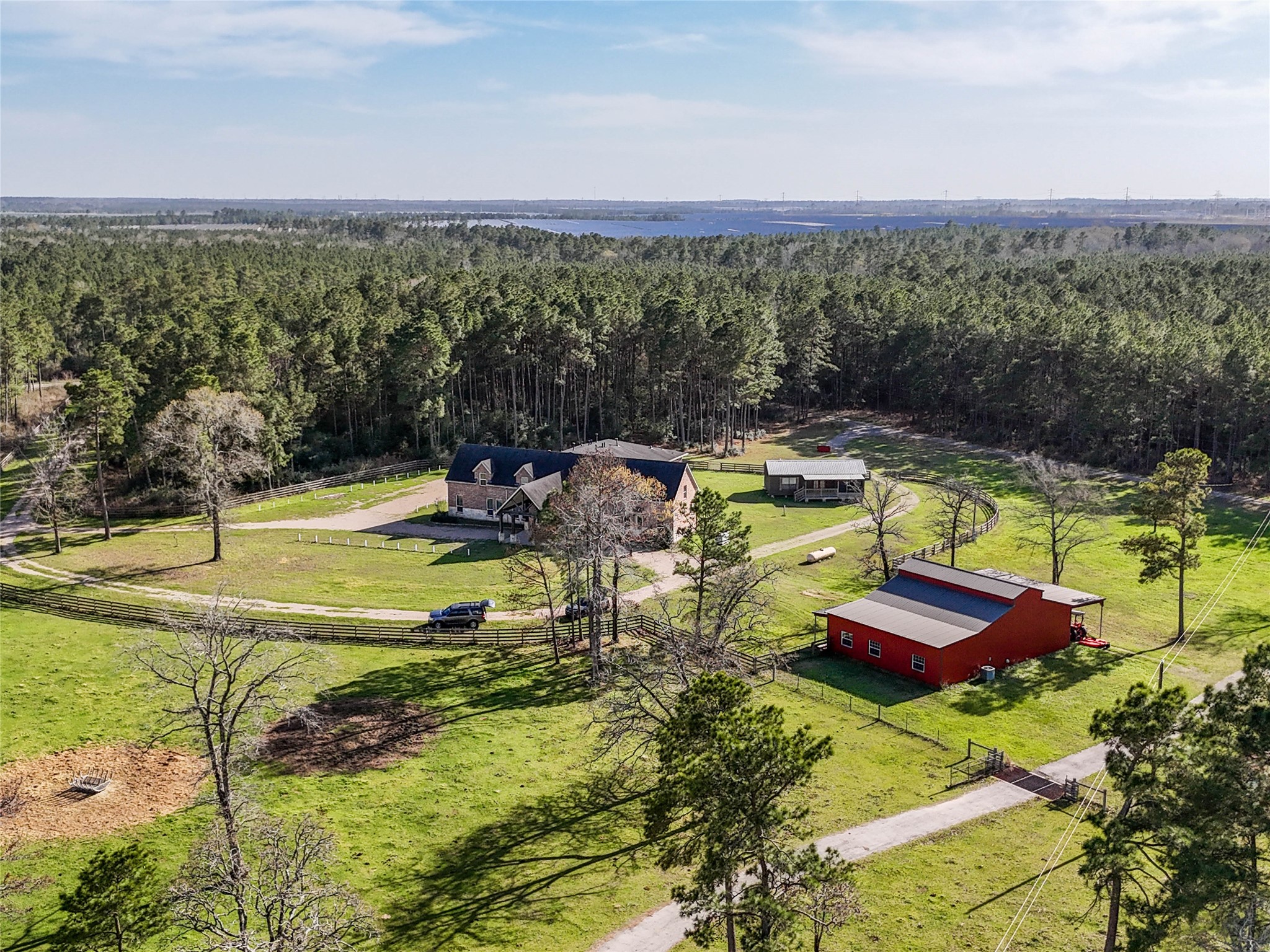 26250 A Riley Road Waller, TX 77484 - Photo 27 of 50 Aerial view highlights the retreat, 2,200-sf barn, and 720-sf cabin—flexible for guests, events, or multi-generational living.