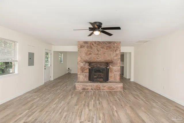 a view of a livingroom with a fireplace and a ceiling fan