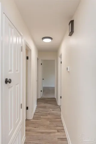 a view of a hallway with wooden floor