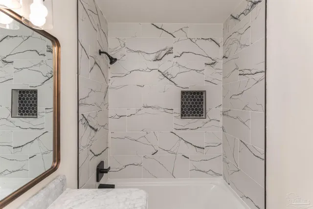 a bathroom with a bathtub and shower