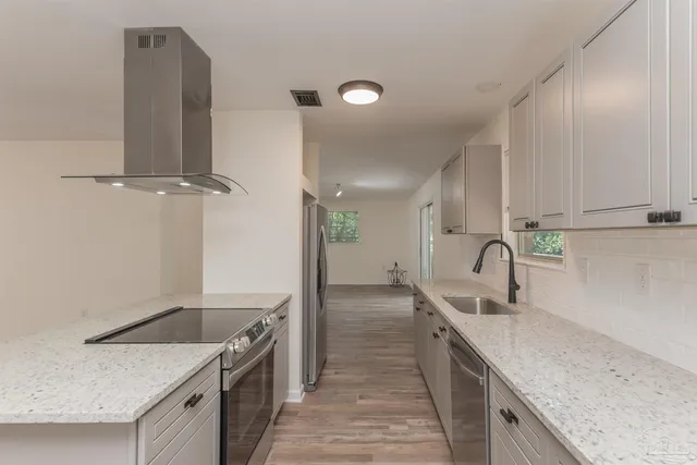 a kitchen with a sink and refrigerator