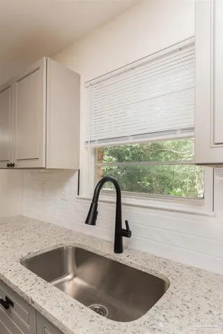 a kitchen with a sink a counter and a window