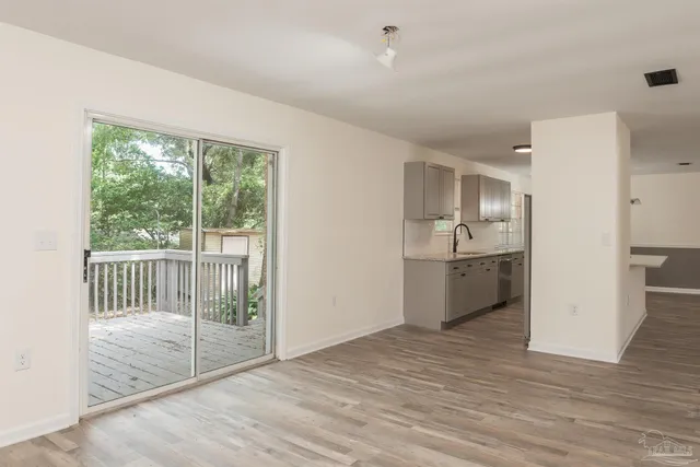 a view of a kitchen with a sink and a window