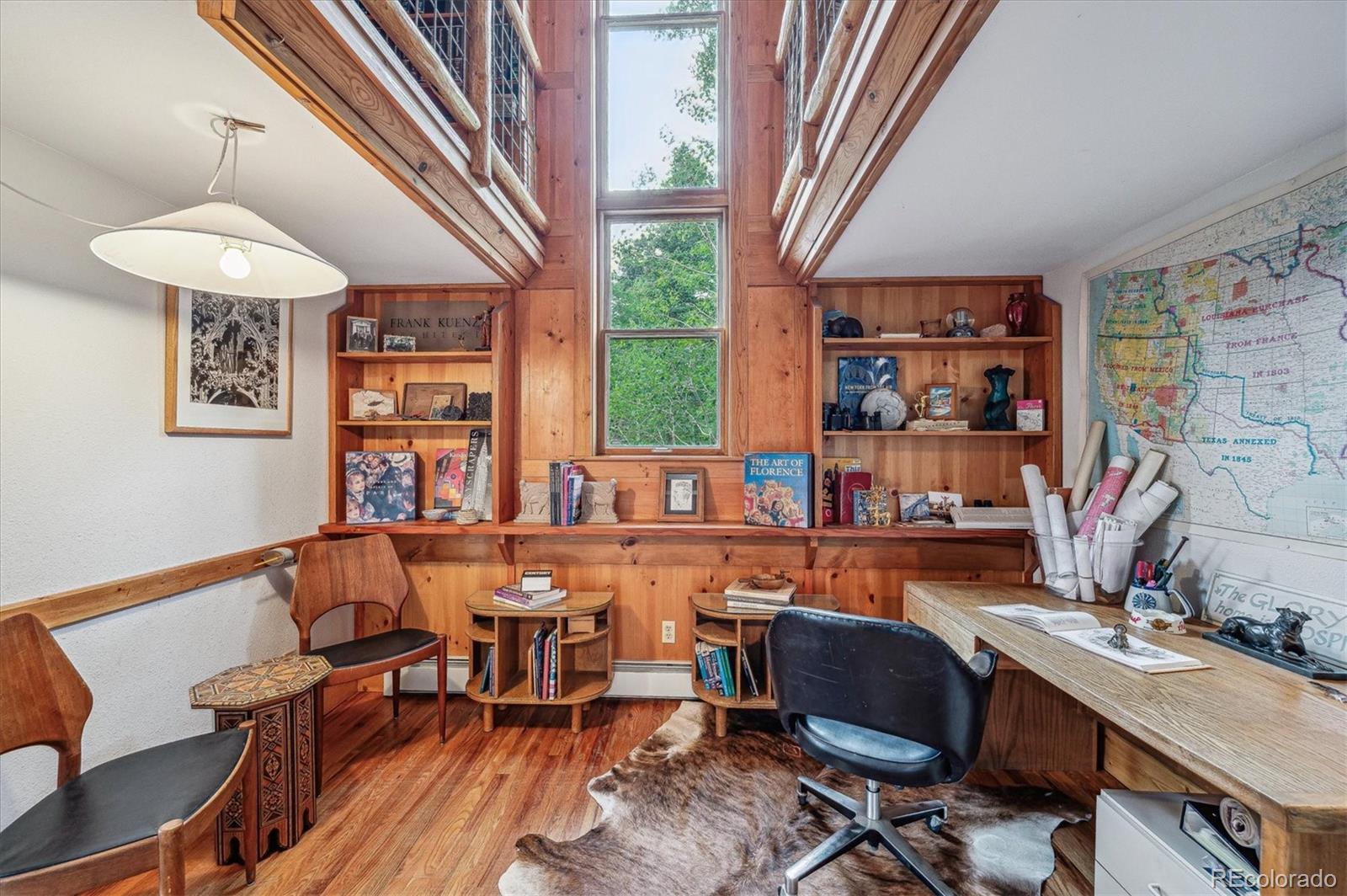 12973 Upper Ridge Road Conifer, CO 80433 - Photo 14 of 46 a room with furniture and a chandelier