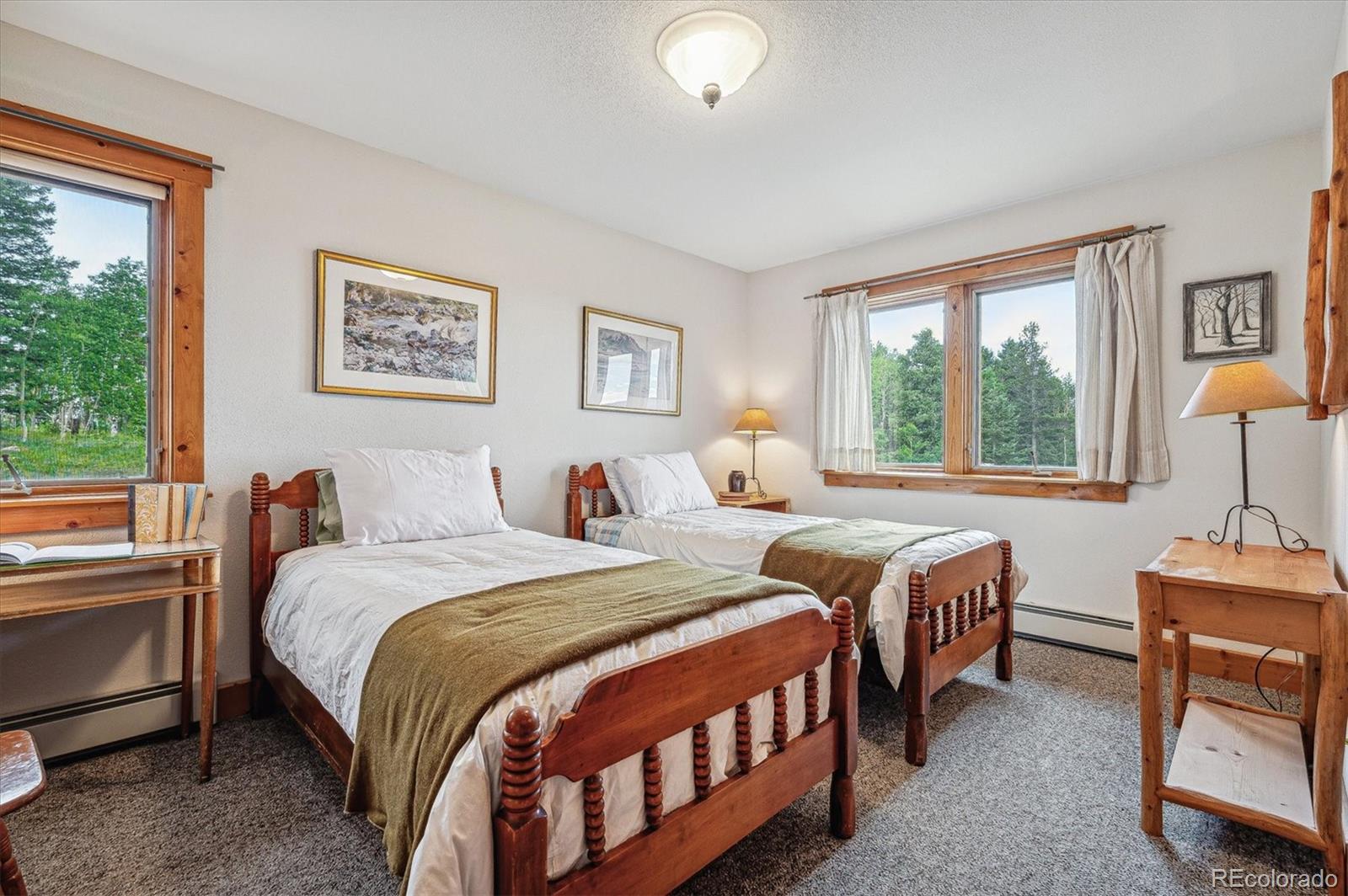 12973 Upper Ridge Road Conifer, CO 80433 - Photo 22 of 46 a bedroom with two beds and a large window