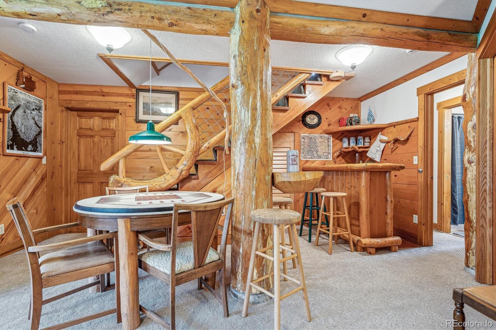 12973 Upper Ridge Road Conifer, CO 80433 - Photo 27 of 46 a view of a patio with table and chairs