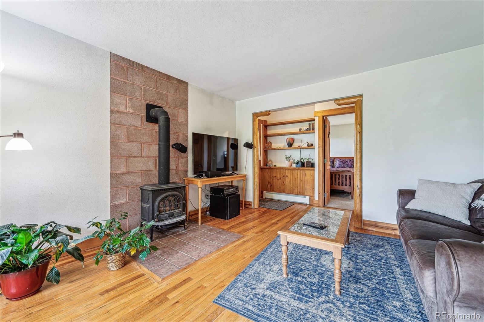 12973 Upper Ridge Road Conifer, CO 80433 - Photo 29 of 46 a living room with furniture and a flat screen tv