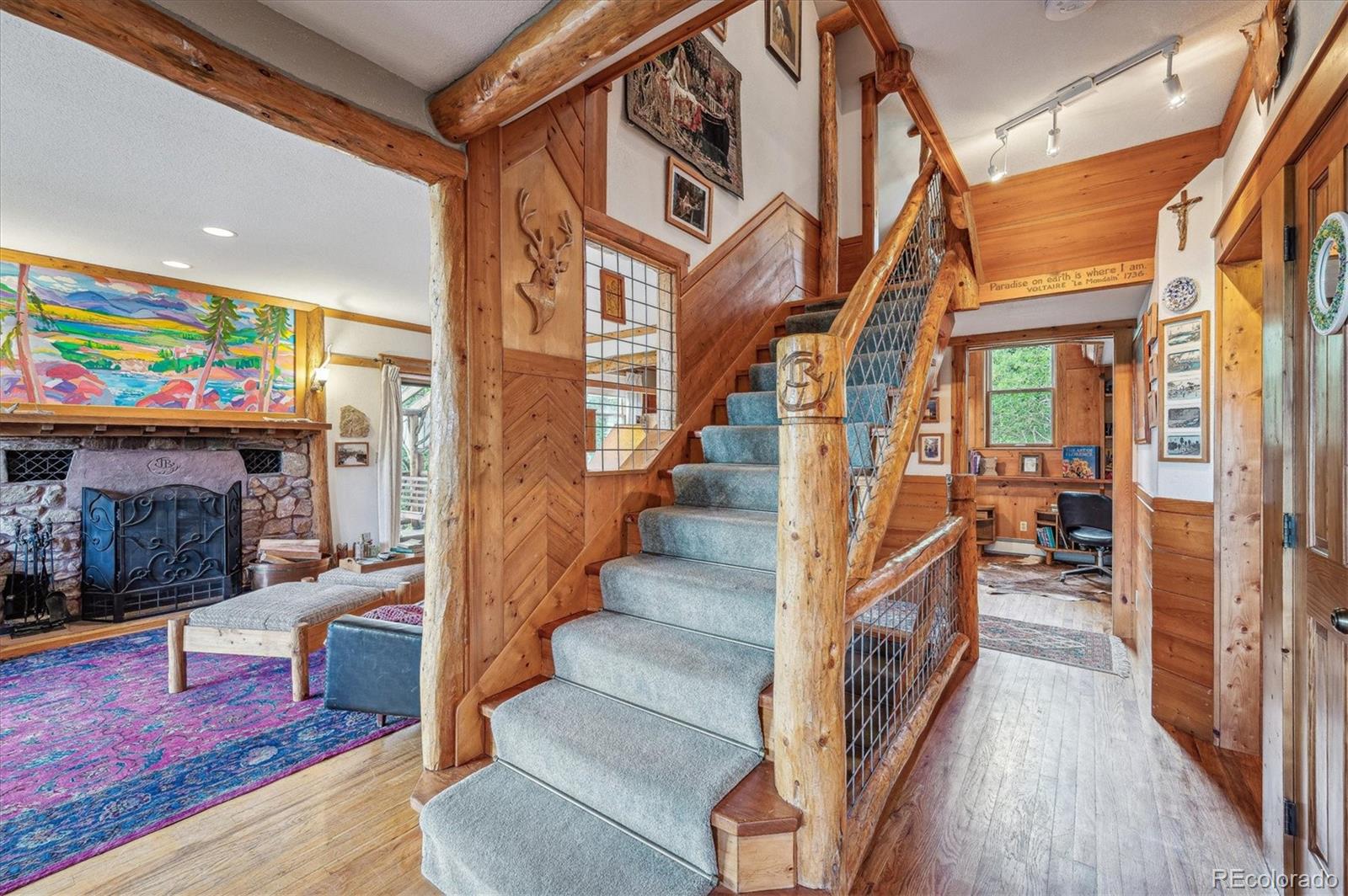 12973 Upper Ridge Road Conifer, CO 80433 - Photo 3 of 46 a view of entryway and hall with wooden floor