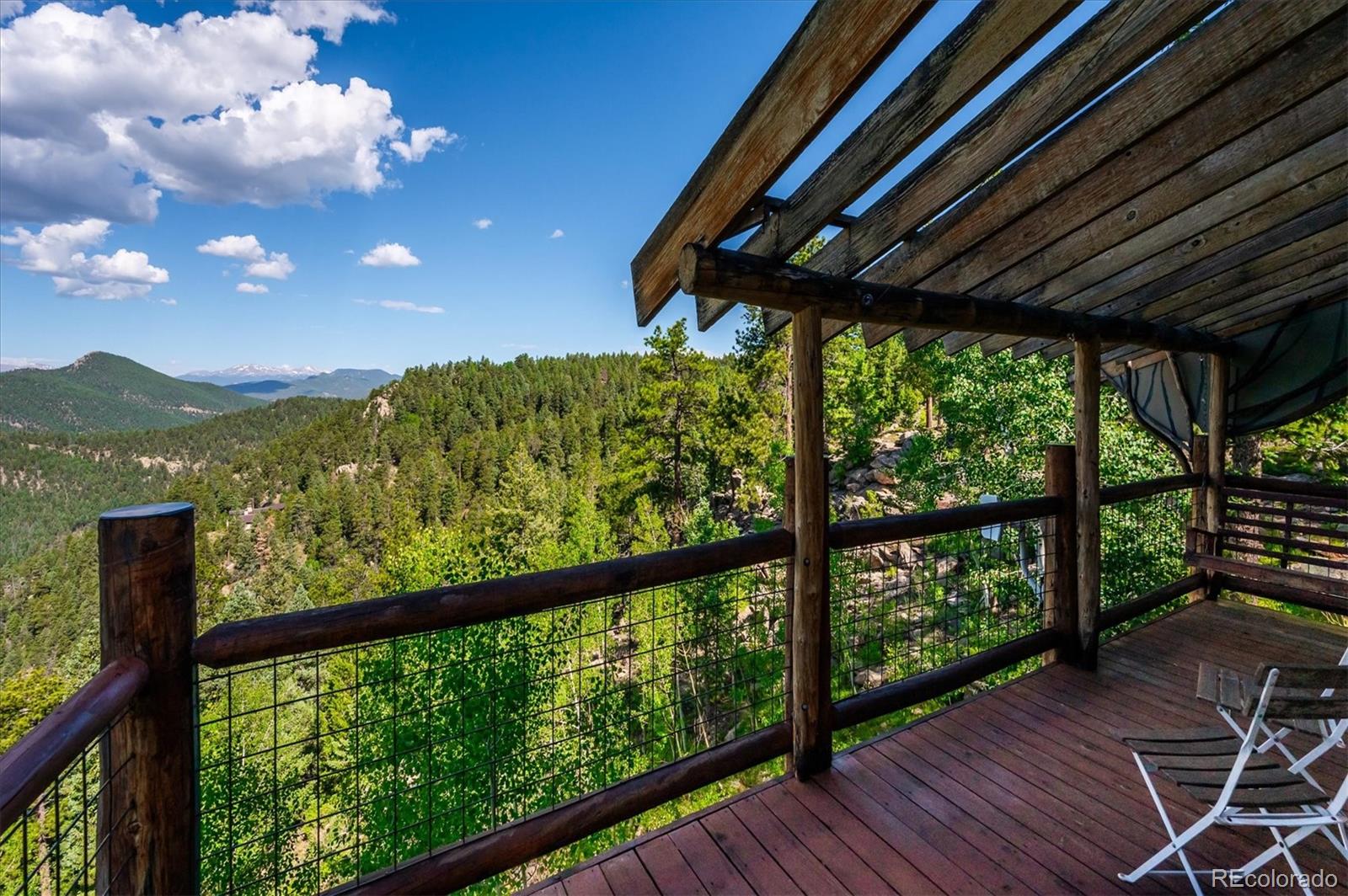 12973 Upper Ridge Road Conifer, CO 80433 - Photo 7 of 46 a view of a porch