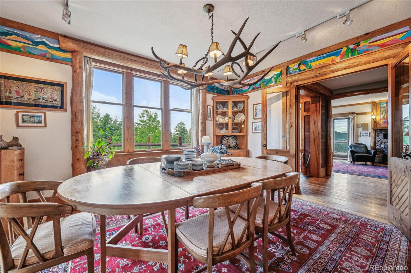 12973 Upper Ridge Road Conifer, CO 80433 - Photo 9 of 46 a view of a dining room with furniture window and outside view