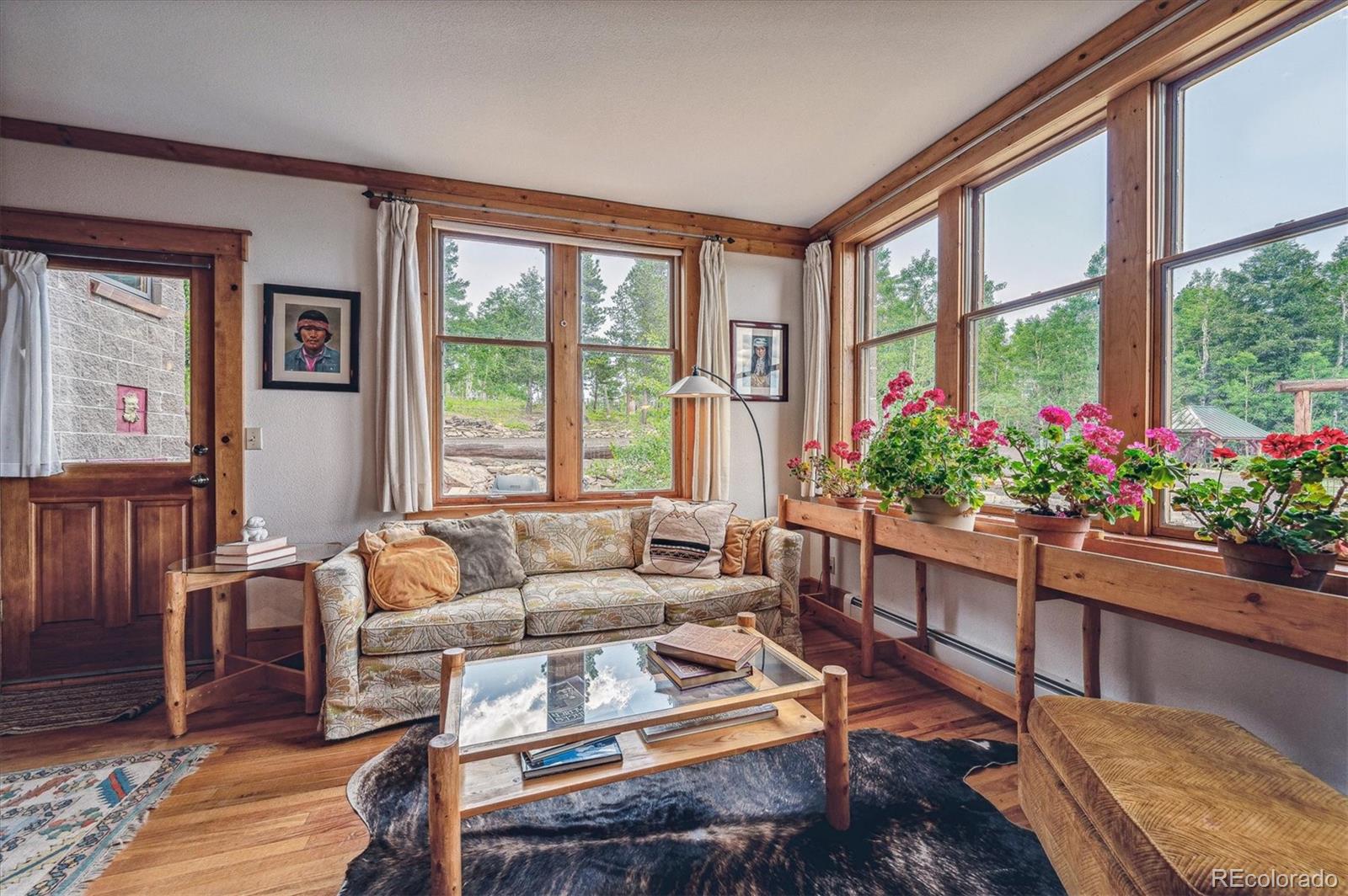 12973 Upper Ridge Road Conifer, CO 80433 - Photo 10 of 46 a living room with furniture and a large window