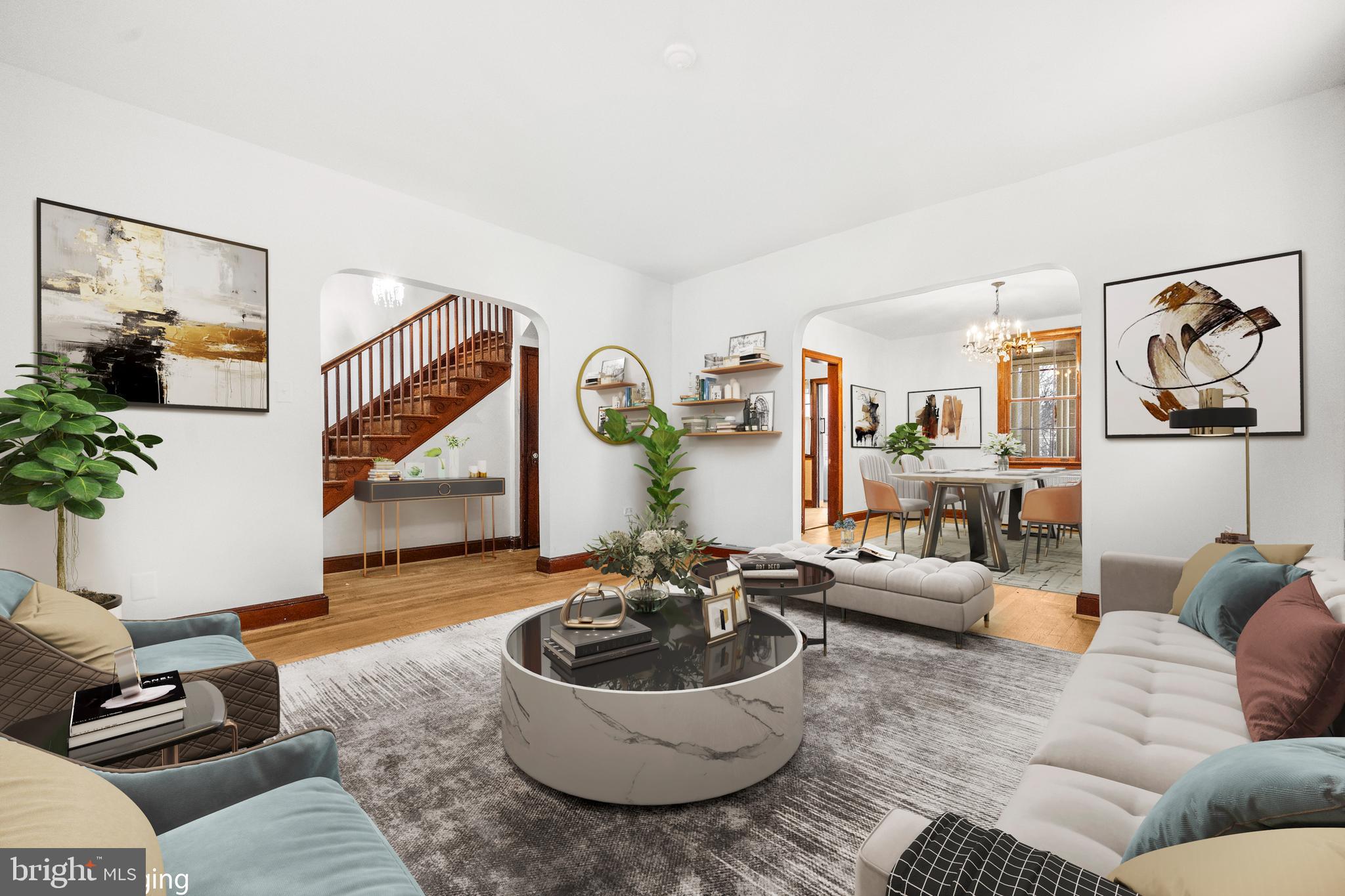 a living room with furniture and a potted plant