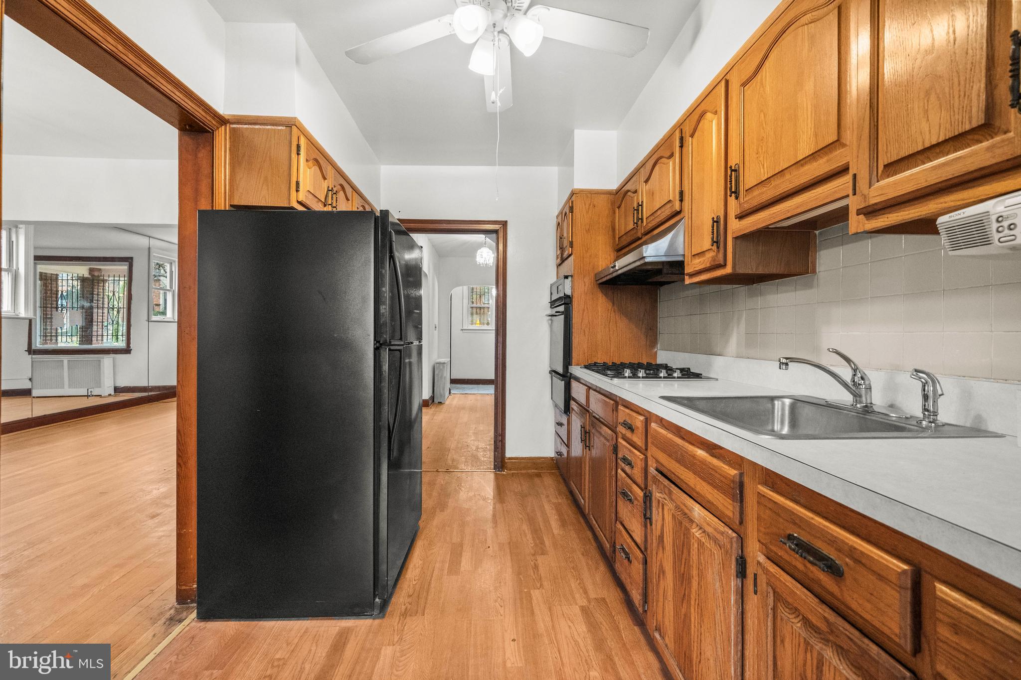 4108 Grant Street Northeast Washington, DC 20019 - Photo 12 of 31 a kitchen with stainless steel appliances granite countertop a refrigerator a sink dishwasher a stove and a dining table with wooden floor