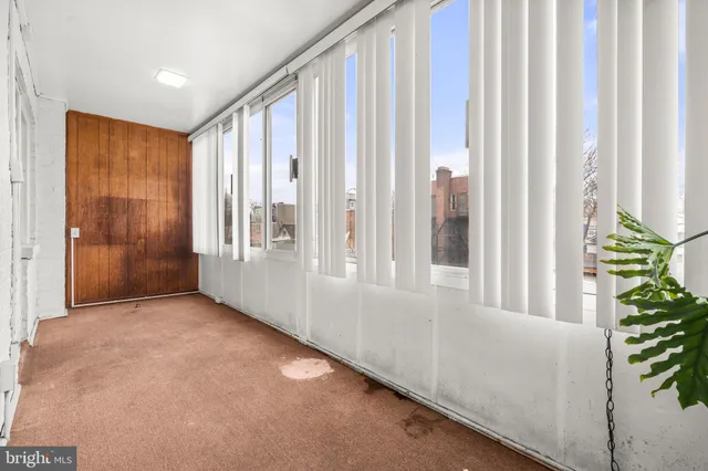 a view of an empty room and a window