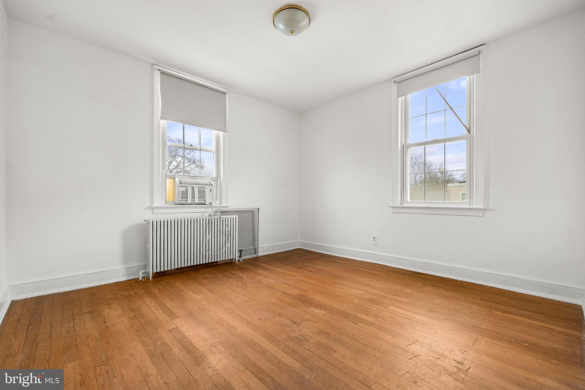 4108 Grant Street Northeast Washington, DC 20019 - Photo 18 of 31 an empty room with wooden floor and windows