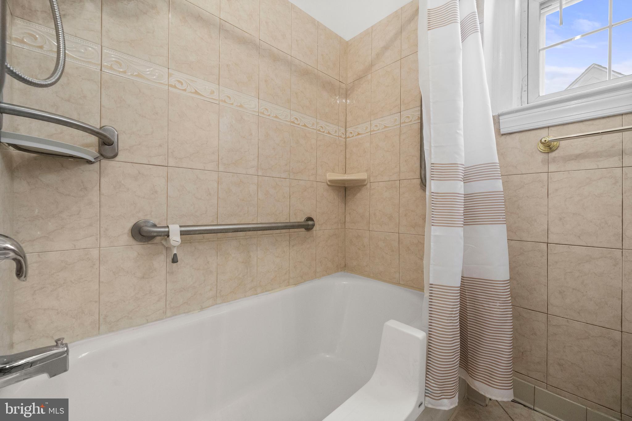 4108 Grant Street Northeast Washington, DC 20019 - Photo 20 of 31 a bathroom with a white bath tub and shower